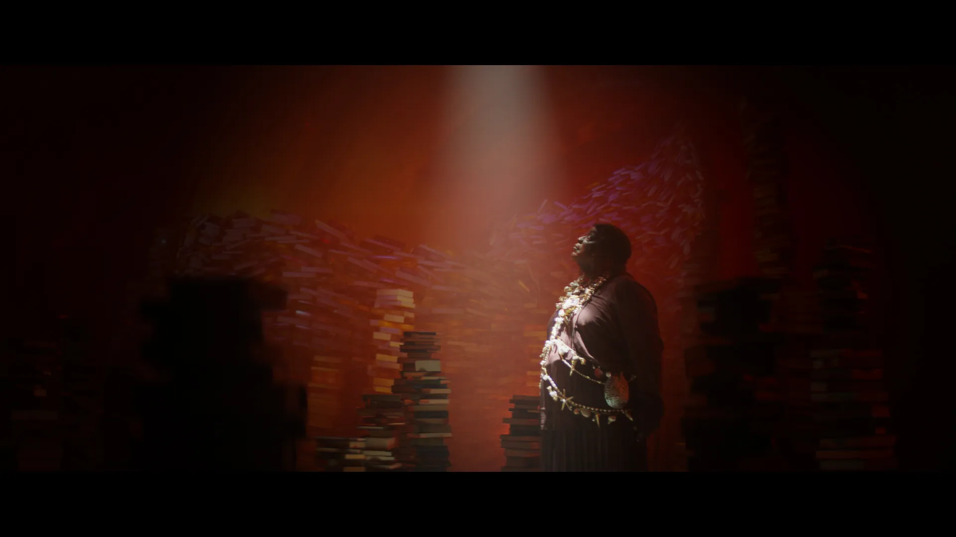 The librarian surrounded by piles of books, possibly in the belly of the whale